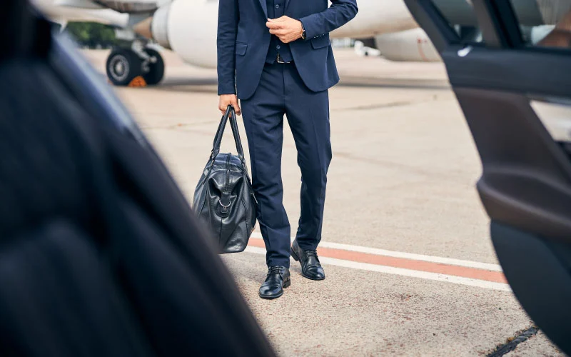 Corporate clients boarding a modern airport coach in London.