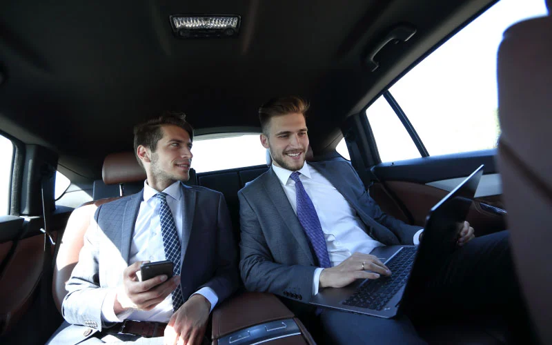 Corporate team boarding a modern shuttle bus in London for a business event.